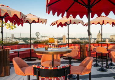 Madrid rooftop with red umbrellas.