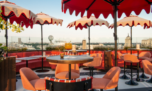 Madrid rooftop with red umbrellas.