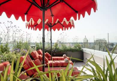 Hotel sundeck with red umbrellas .
