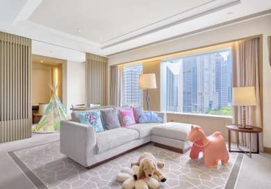 Luxurious living room with L-sofa and skyline views.