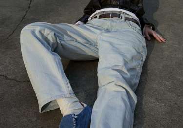 Model wearing blue aloha trainers .