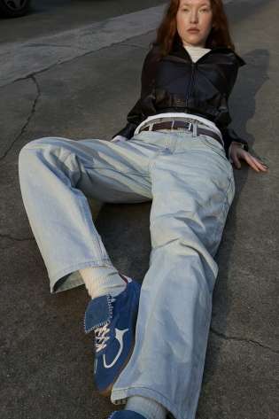 Model wearing blue aloha trainers .