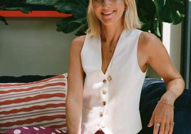 Headshot of philippa thackeray posing in polka dot trousers and white waistcoat.