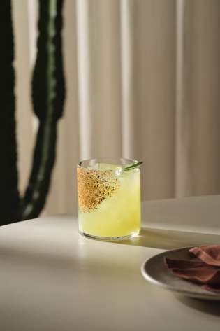 Yellow cocktail at mexican restaurant .