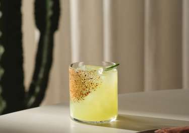 Yellow cocktail at mexican restaurant .