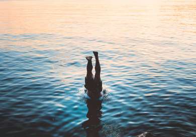 Person diving into sea.