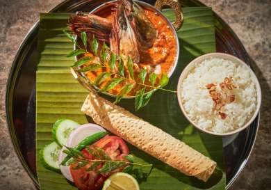 Tray laden with freshly-cooked food .