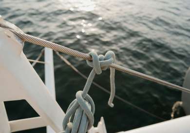 Close-up of luxury yacht with pale blue rope.