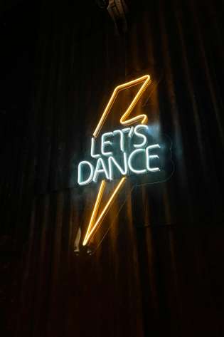 Let's dance neon light with electric bolt.