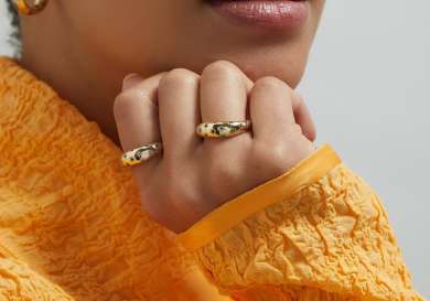 Model wearing gold rings with star embellishments.