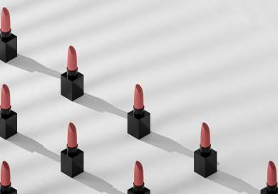 Lipsticks lined up in rows .