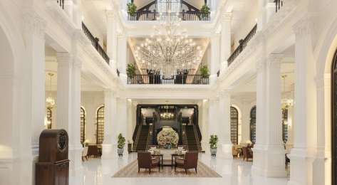 Lobby of hotel with chandelier.