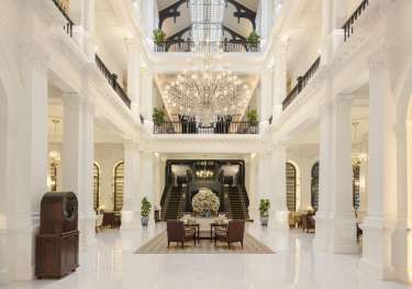 Lobby of hotel with chandelier.