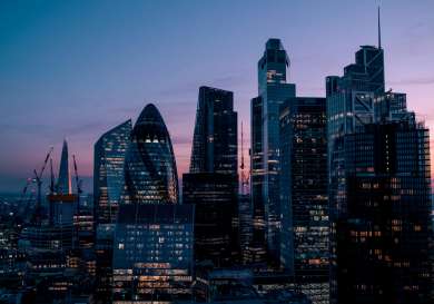 London skyline with setting sun behind .