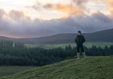Luke selby posing on hilltop.