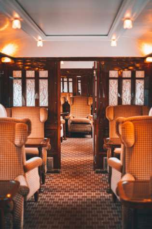Luxury red seating inside orient express train .