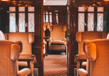 Luxury red seating inside orient express train .
