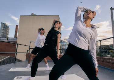 Three people doing yoga.