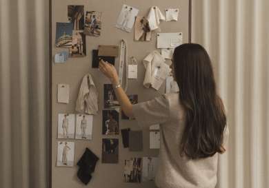 Designer looking at inspiration board.