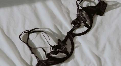 Black bra on white sheet.