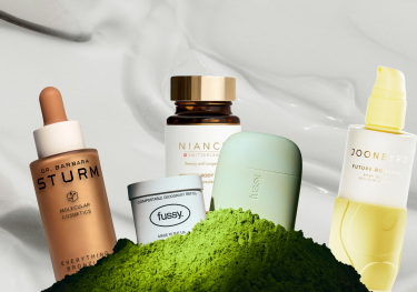 Array of beauty and wellness products on white cream background.