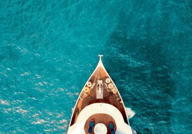 Private boat sailing in turquoise waters .