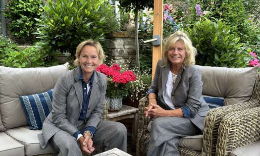 Photo of MOLOH founders sat around wooden table.