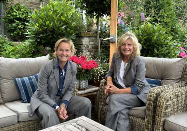 Photo of MOLOH founders sat around wooden table.