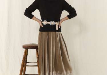Model posing in velvet skirt.