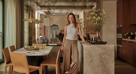Headshot of rebecca hughes standing in kitchen .