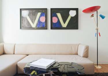 Hotel junior suite with artwork on walls .