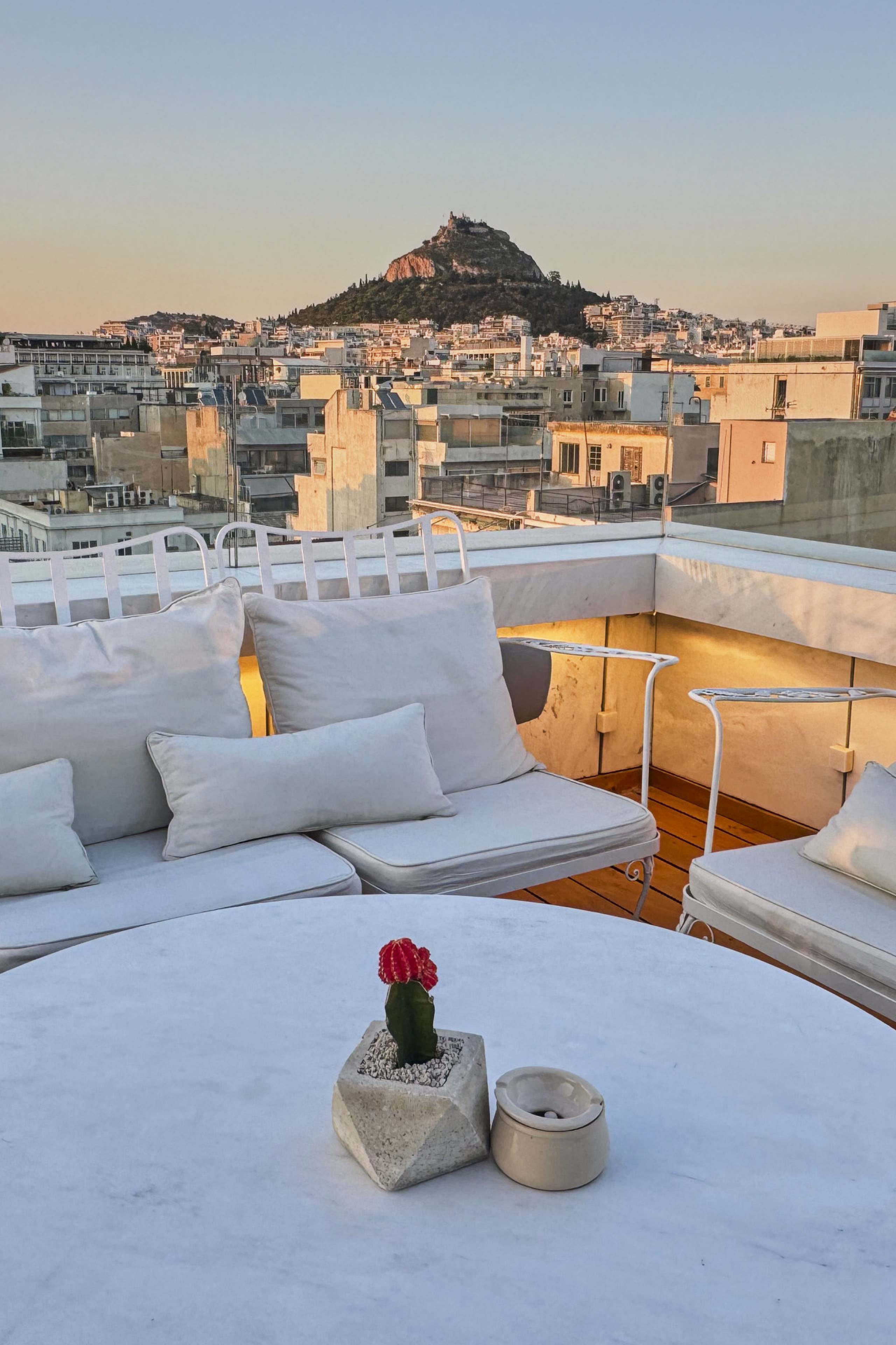 hotel rooftop area with round table and chairs
