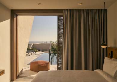 Hotel bedroom with open to private pool .