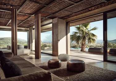 Photo of hotel lobby with sliding doors to outside area .