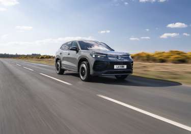 Car driving along empty road.