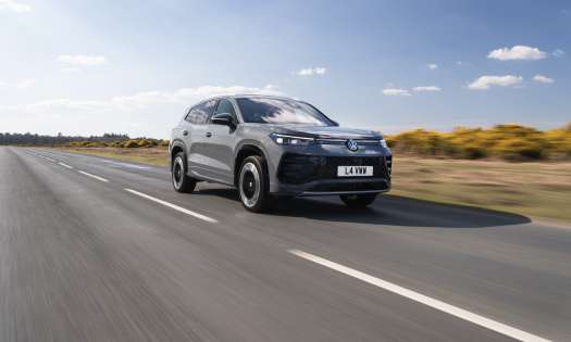 Car driving along empty road.