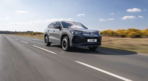 Car driving along empty road.