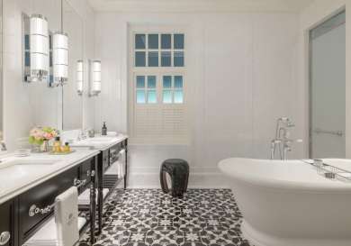 Hotel bathroom with bath tub .