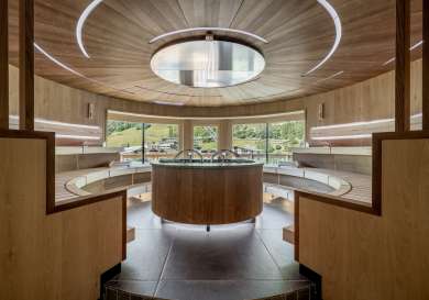 Spa inside austrian hotel with natural wood and windows .