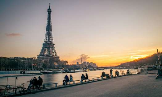 Photo of eiffel tower next to the seine.