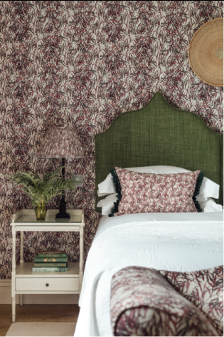 Hotel bedroom with pink and green accents .