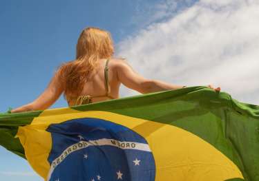 Woman holding brazil flag.