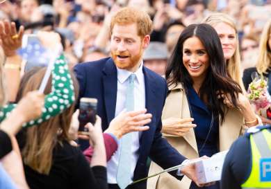 Prince harry and meghan greeting crowds of wellwishers in australia.