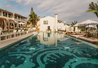 View of outdoor swimming pool at hotel .