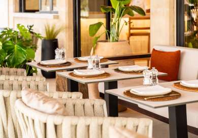 Photo of tables and chairs at hotel restaurant.