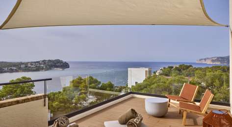 View of terrace in hotel room with sea view.