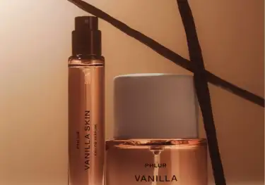 Phlur vanilla skin perfume with two vanilla pods .