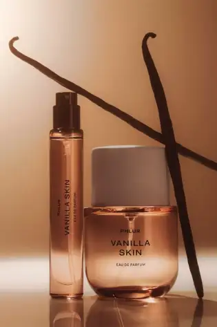 Phlur vanilla skin perfume with two vanilla pods .