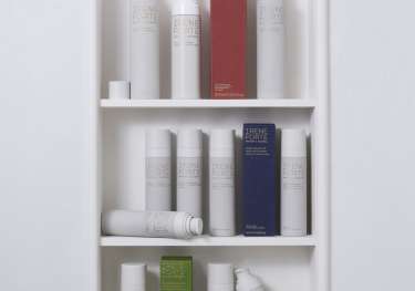 Skincare products in curved shelving .