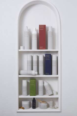 Skincare products in curved shelving .